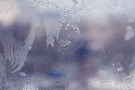 Winter ice pattern on the frozen window. Texture, background for inserting text. New Year theme. Winter. Cold.の写真素材
