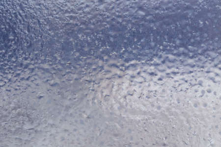 Winter ice pattern on the frozen window. Texture, background for inserting text. New Year theme. Winter. Cold.の写真素材