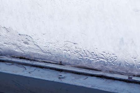 Winter ice pattern on the frozen window. Texture, background for inserting text. New Year theme....
