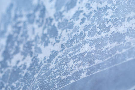 Winter ice pattern on the frozen window. Texture, background for inserting text. New Year theme....