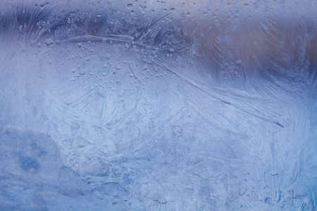 Winter ice pattern on the frozen window. Texture, background for inserting text. New Year theme. Winter. Cold.の写真素材