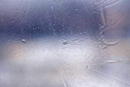 Winter ice pattern on the frozen window. Texture, background for inserting text. New Year theme. Winter. Cold.の写真素材