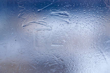 Winter ice pattern on the frozen window. Texture, background for inserting text. New Year theme. Winter. Cold.の写真素材