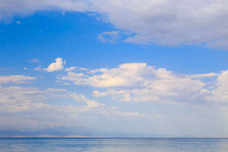 Blue sky with white cumulus clouds. Abstract natural background.の写真素材