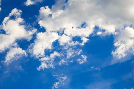 Blue sky with white cumulus clouds. Abstract natural background.