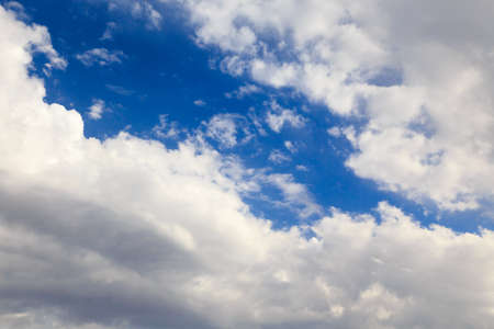 Blue sky with white cumulus clouds. Abstract natural background.