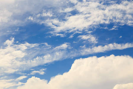 Blue sky with white cumulus clouds. Abstract natural background.