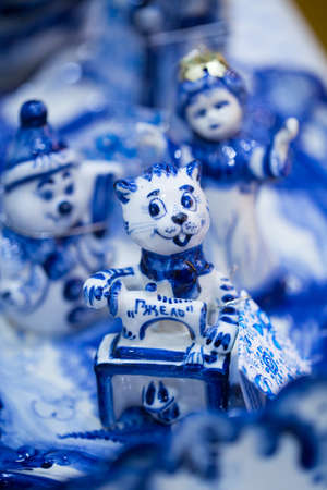 Fair with dishes and souvenirs in Russian traditional style. Traditional colors are blue and white. Gzhel - Russian folk craft from ceramics and porcelain production. Close-up.の写真素材