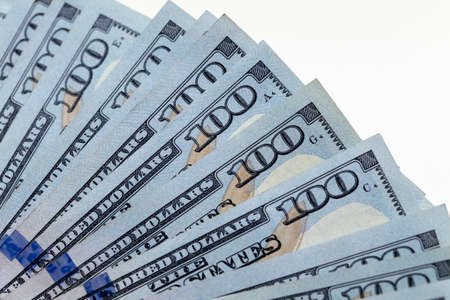 A bundle of hundred dollar bills laid out like a fan. On a white background. Background of dollar bills. American Dollars Cash Money. Hundred Bucks.の写真素材