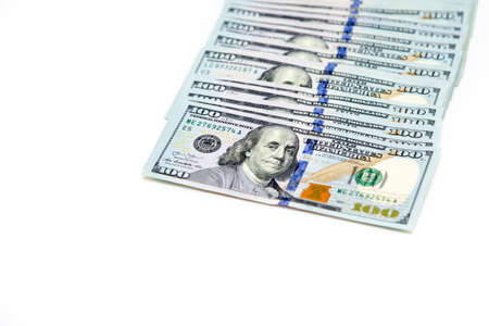 A bundle of hundred dollar bills laid out like a fan. On a white background. Background of dollar...