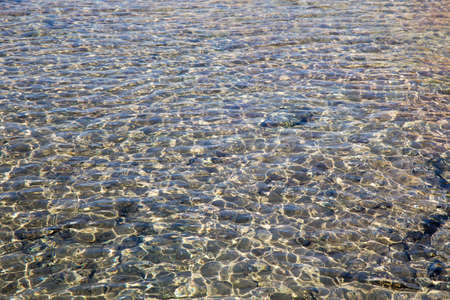 Beautiful coastline with sand and water. blue sea wave photograph close up. Background to insert images and text.の写真素材