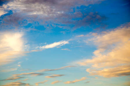 Bright blue sky with gentle cumulus clouds. Natural summer and spring background.
