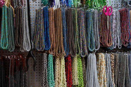 Multicolored handmade beads. Colorful background of the bead. Fashionable craft of women. Decoration of stones.の写真素材