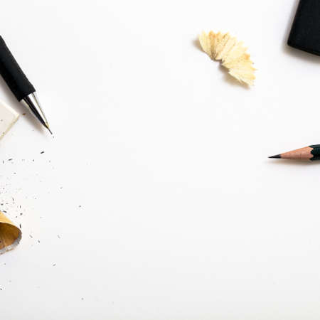 Background with white paper, pencils and eraser. Workplace for the painter. Background to display...