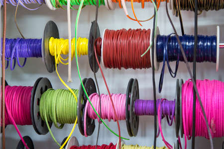 multicolored threads and ribbons. Background for the store selling reels with ribbons. materials for sewing and creativity. Fashionable craft of women.の写真素材