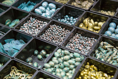 beads in different boxes. Material for handmade jewelery. Background for the store and the master. Shop for creativity.の写真素材