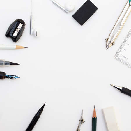 Background with white paper, pencils and eraser. Workplace for the painter. Background to display...