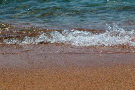 sandy beach and blue sea wave. Beautiful natural background. Tourism and travel.
