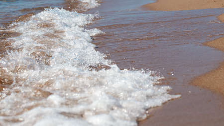 sandy beach and blue sea wave. Beautiful natural background. Tourism and travel