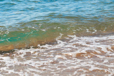 sandy beach and blue sea wave. Beautiful natural background. Tourism and travel