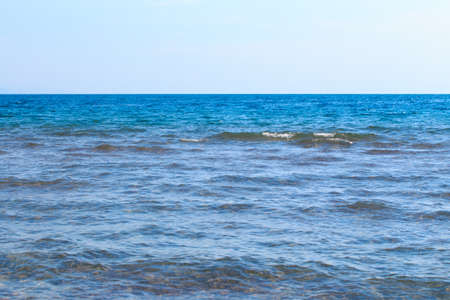Clear water texture in blue and orange. Background of the ocean and the sea backlit by the sun. Natural waterの写真素材