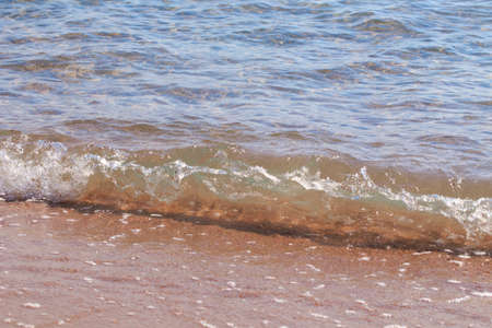 sandy beach and blue sea wave. Beautiful natural background. Tourism and travel