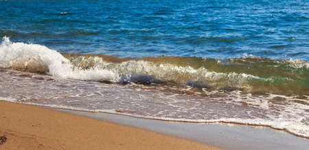 sandy beach and blue sea wave. Beautiful natural background. Tourism and travel