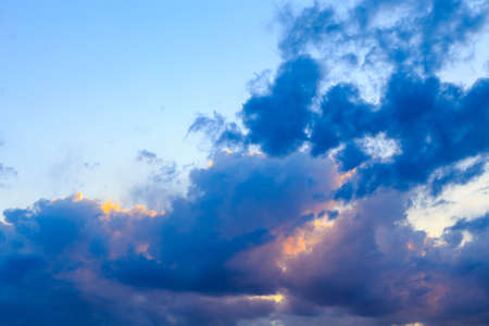Bright cumulus clouds against the blue sky. Sunset sky Natural background.の写真素材