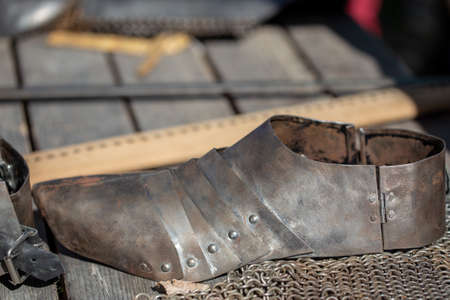 Medieval protective metal boot. Vintage thing