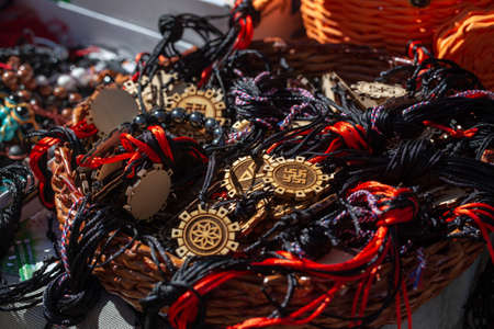 wooden decorations with a sun sign. On the laces of their fabric. Jewelry texture.の写真素材