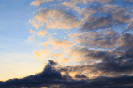 Bright cumulus clouds against the blue sky. Sunset sky Natural background.