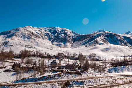 Mountains with melting snow. The end of winter, the beginning of spring. Kyrgyzstan Tourism and travelの写真素材