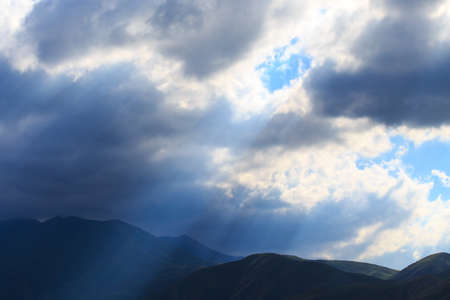 Bright cumulus clouds against the blue sky. Sunset sky Natural backgroundの写真素材