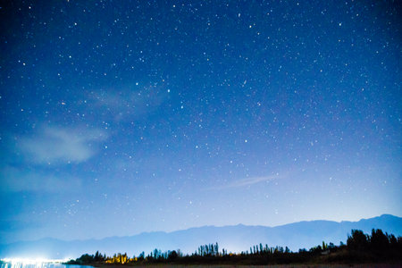 Starry sky and clouds. Over the high mountains.の写真素材