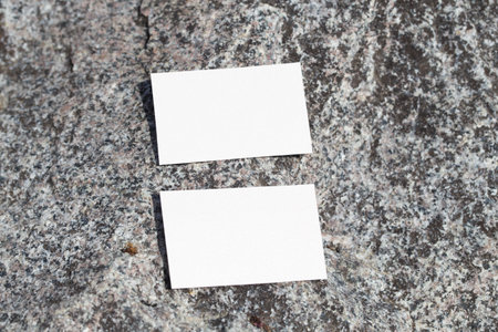 Blank business card mockup on a background of stones. Blank white business card mockup for your business card design. Branding Mock up.の写真素材