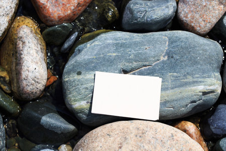 Blank business card mockup on a background of stones. Blank white business card mockup for your business card design. Branding Mock up.の写真素材