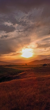 Sunset over autumn fields. Beautiful natural background. Golden autumn.