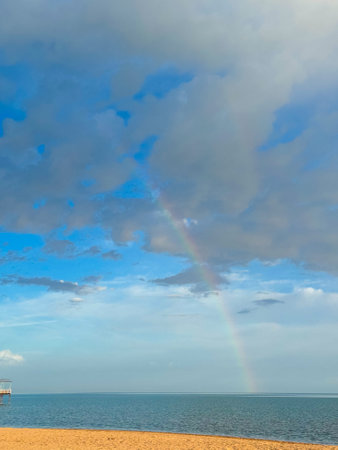 Rainbow on the seashore. Sky after rain and sandの写真素材