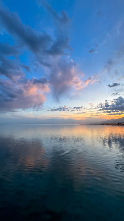 Beautiful sunset on the lake. Mountains and water. Kyrgyzstan