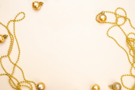 Stylish winter layout with white presents, gold bows and sparkling ornaments on beige background....