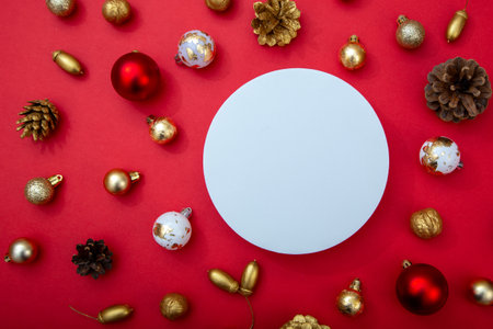 Elegant Christmas background with white circle in center and golden ornaments around. Perfect for advertising and festive banner design.の写真素材