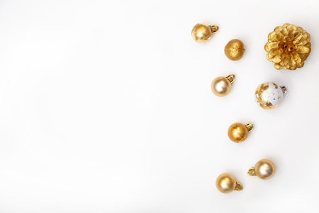 White Christmas background with copy space and golden decorations. Stylish minimalist composition for cards, banners and holiday adsの写真素材