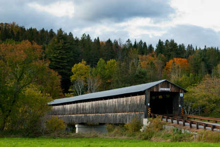 Covered bridge in New England guides travelers in Autumn.
