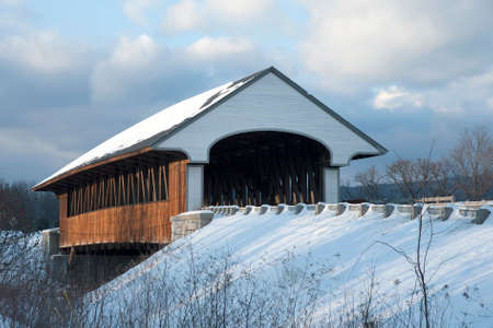 Covered bridge after New England snowfall.