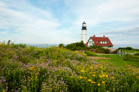 Wildflowers surround Portland Head lighthouse on a warm summ er day in Maine. It is Maineâs oldest beacon.の写真素材