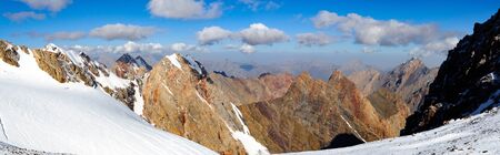 mountain peaks with glacier against a blue skyの写真素材