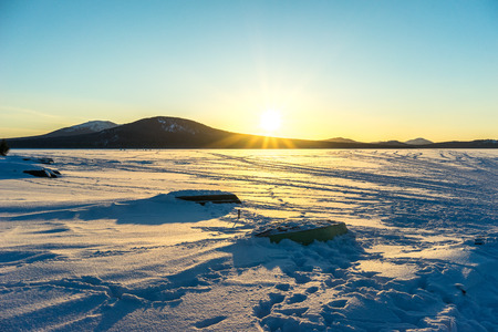 Boats on the lake Zuratkul on winterの写真素材