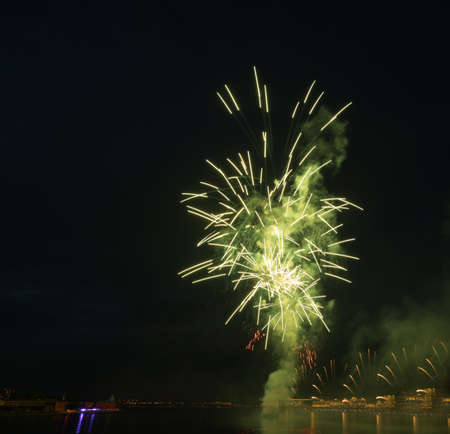 night city celebration holiday bright firework above river long exposure shootの写真素材