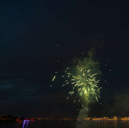 night city celebration holiday bright firework above river long exposure shootの写真素材