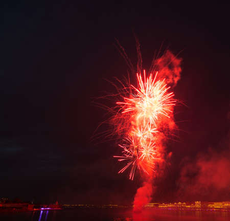 night city celebration holiday bright firework above river long exposure shootの写真素材